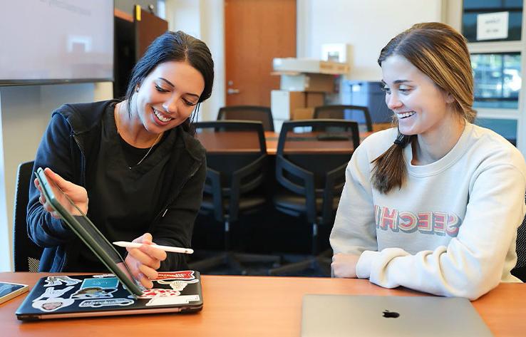 two students work together in a class